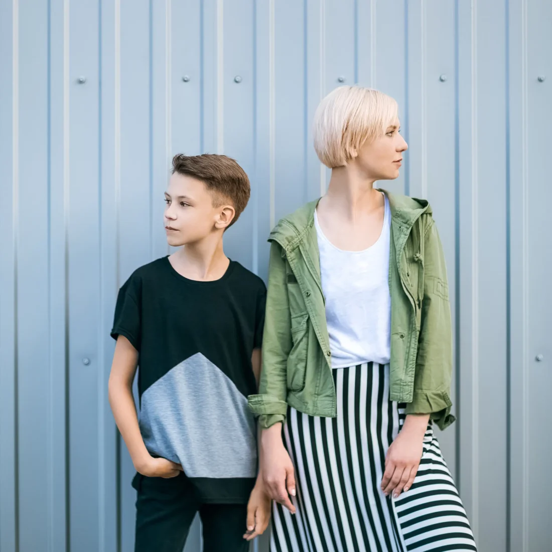 beautiful-stylish-mother-and-son-looking-away-whil-2023-11-27-05-28-52-utc